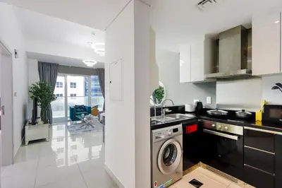 a kitchen with a washer and a washing machine at 1BR with Balcony, Steps from JBR & Marina Walk in Dubai