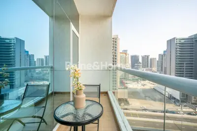 a balcony with a table and a view of a city at RH- Modern studio walk away from Burj khalifa and Dubai Mall in Dubai