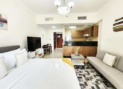 a living room with a large bed and a couch at RH- Contemporary Living, Studio, Near Burj Khalifa in Dubai