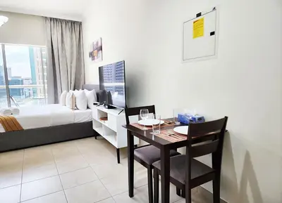 a bedroom with a table and a bed with a window at RH- Contemporary Living, Studio, Near Burj Khalifa in Dubai