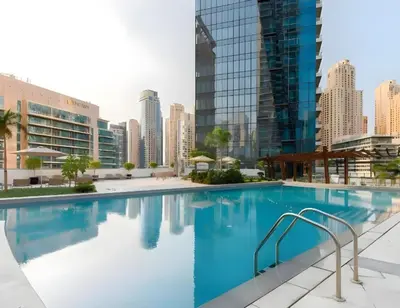 a swimming pool with a city skyline in the background at Gala Guests - Silverene Tower Marina Living Apartments in Dubai