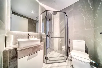 a bathroom with a shower and a sink and a toilet at Tranquil 2BR with Assistant Room at Mesk 1 Midtown Dubai Production City by Deluxe Holiday Homes in Dubai