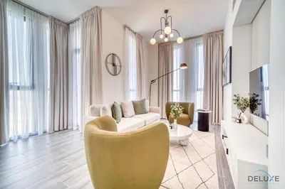 a living room with a couch and a table at Peaceful 2BR with Assistant Room at Mesk 1 Midtown Dubai Production City by Deluxe Holiday Homes in Dubai