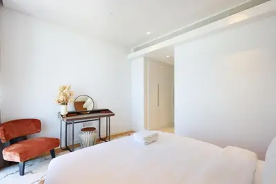 a white bedroom with a bed and a desk at Livbnb - Alluring 3BR Plus Maid's with Sea & Ain Dubai View in Dubai