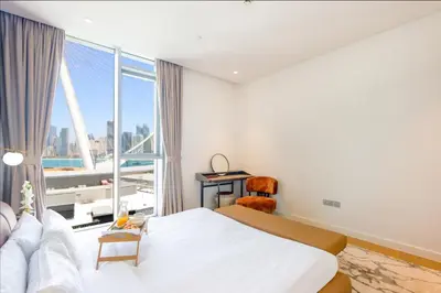 a hotel room with a bed and a large window at Livbnb - Alluring 3BR Plus Maid's with Sea & Ain Dubai View in Dubai