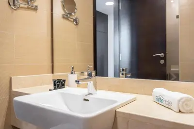 a bathroom with a white sink and a mirror at Sleek Studio in Dubai's Vibrant JBR Neighborhood in Dubai