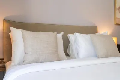 a bedroom with a bed with white pillows at Sleek Studio in Dubai's Vibrant JBR Neighborhood in Dubai