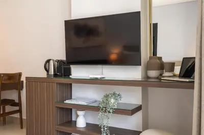 a flat screen tv sitting on top of a shelf at Sleek Studio in Dubai's Vibrant JBR Neighborhood in Dubai