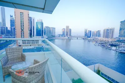 a balcony with a view of a river in a city at Alashrafia Saray- Cozy 2BR apartment in Canal Views in Dubai