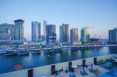 a view of a city with a river and buildings at Alashrafia Saray- Cozy 2BR apartment in Canal Views in Dubai