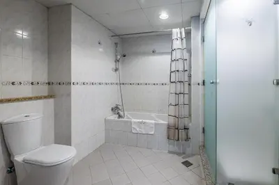 a bathroom with a toilet and a bath tub at Spacious Apartment I Lake Views Apartment in JLT I Close To Metro in Dubai