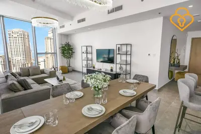 a dining room and living room with a table and chairs at Keysplease Luxury 3 B/R Fascinating Sea & Dubai Marina Views in Dubai