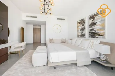 a white bedroom with a large bed and a desk at Keysplease Luxury 3 B/R Fascinating Sea & Dubai Marina Views in Dubai