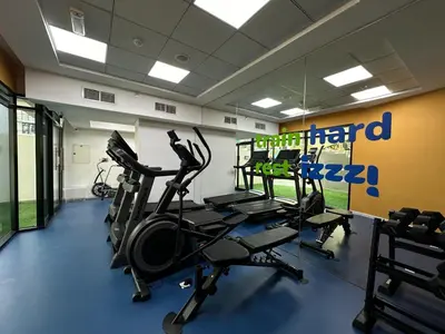 a gym with treadmills and ellipticals in a room at Izzzi Life Mint in Dubai