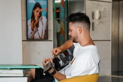 a man with a beard sitting in a machine at Izzzi Life Mint in Dubai