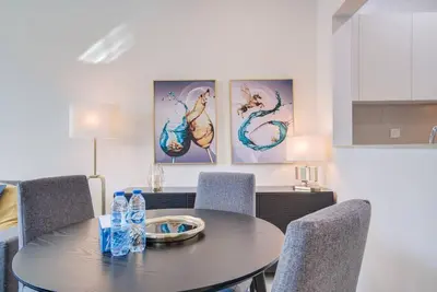 a dining room table with chairs and water bottles on it at Canal View l Stylish & Spacious in Dubai