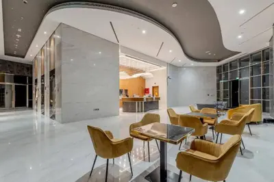 a lobby with a table and chairs and a kitchen at Canal View l Stylish & Spacious in Dubai