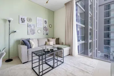 a living room with a couch and a table at GuestReady Holiday Homes - Sobha Urban Retreat in Dubai