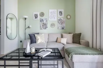 a living room with a couch and a table at GuestReady Holiday Homes - Sobha Urban Retreat in Dubai
