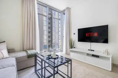 a living room with a couch and a tv at GuestReady Holiday Homes - Sobha Urban Retreat in Dubai