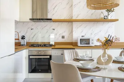a kitchen with a table and a white counter top at GuestReady Holiday Homes - Boho Marina Dream in Dubai