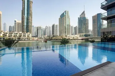 a large swimming pool in a city with tall buildings at GuestReady Holiday Homes - Boho Marina Dream in Dubai
