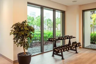 a room with a potted plant and a large window at Prime Retreats @ Burj Royale By Emaar in Dubai