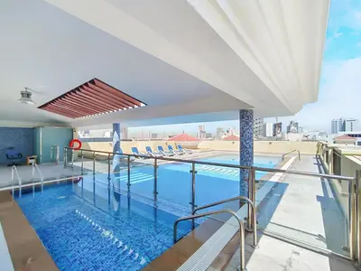 a swimming pool on top of a building at Lower floor studio with a sofa bed in JVC - Allsopp&Allsopp in Dubai