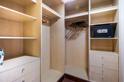 a walk in closet with a tv and a tv at Spacious 2-bedroom beachfront apartment with pool in Dubai