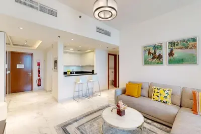 a living room with a couch and a table at Meera Tower - Sleek One Bedroom in Dubai