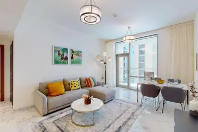 a living room with a couch and a table at Meera Tower - Sleek One Bedroom in Dubai