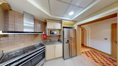 a kitchen with a stainless steel refrigerator at Al Dabas Beach Views, 3BD Sleeps 6, Beachfront Beach & Pool Access - DVH Holiday Homes in Dubai