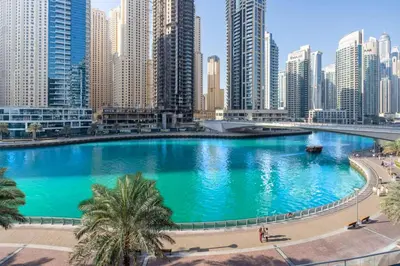 a large pool in a city with tall buildings at Serene 1BR with Stunning Marina Views in Dubai Marina - The Atlantic in Dubai