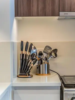 a kitchen counter with utensils on a shelf at Chic 1BR in Park Heights 2 - Dubai Hills in Dubai