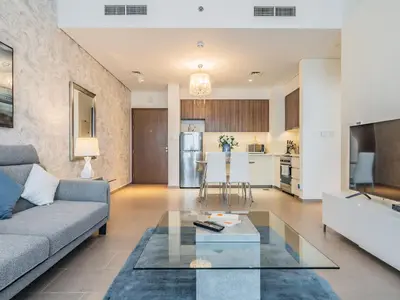 a living room with a couch and a table at Chic 1BR in Park Heights 2 - Dubai Hills in Dubai