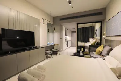 a hotel room with a bed and a television at Studio - MAG 318 in Dubai