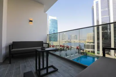 a balcony with a couch and a view of the city at Studio - MAG 318 in Dubai