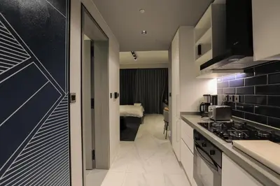 a kitchen with a sink and a stove at Studio - MAG 318 in Dubai