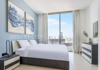 a bedroom with a large bed and a large window at 2 Bed in Sobha Creek Vista Reserve with Burj Khalifa views hosted by Desert City Stays in Dubai