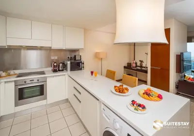 a kitchen with two plates of food on a counter at Deluxe - Address Dubai Mall - The Residence in Dubai
