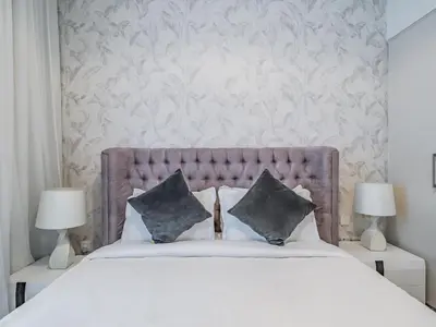 a bedroom with a large bed with two lamps at Stylish 1BR in Park Heights 2 - Dubai Hills in Dubai