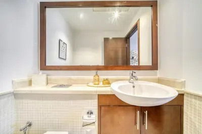 a bathroom with a sink and a mirror at South Ridge 2, Downtown Dubai - Mint Stay in Dubai