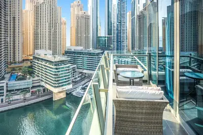 a balcony with chairs and tables in a city at Panoramic Luxe 1BR with Breathtaking Views at Dubai Marina Near JBR - Silverene Towers in Dubai