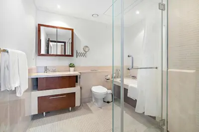 a bathroom with a shower and a toilet and a sink at Silkhaus high floor 1BDR in Southridge in Dubai