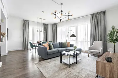 a living room with a couch and a table at Silkhaus high floor 1BDR in Southridge in Dubai