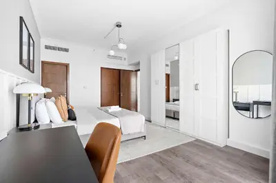a living room with a bed and a table at Silkhaus high floor 1BDR in Southridge in Dubai