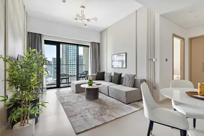 a living room with a couch and a table at Silkhaus elegant 1BDR in Downtown premium tower in Dubai