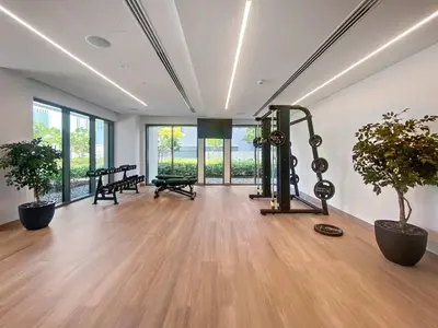 an empty room with a gym with two potted plants at Silkhaus elegant 1BDR in Downtown premium tower in Dubai