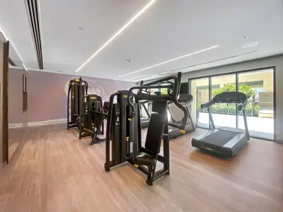 a gym with several tread machines in a room at Silkhaus elegant 1BDR in Downtown premium tower in Dubai