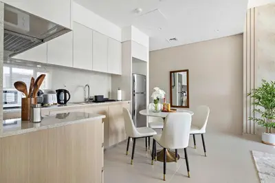 a kitchen and dining room with a table and chairs at Silkhaus elegant 1BDR in Downtown premium tower in Dubai